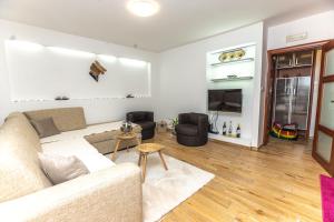 a living room with a couch and a tv at Vukotic in Budva