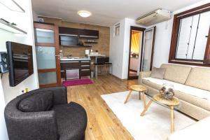 a living room with a couch and a table at Vukotic in Budva
