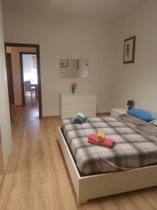 a bedroom with a bed with a red object on it at Casa Iris in La Spezia