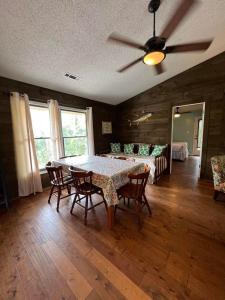 a dining room with a table with chairs and a ceiling fan at Our Anchor in St. George Island +23 photos