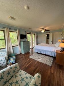 a large bedroom with a bed and a couch at Our Anchor in St. George Island
