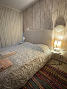 a bedroom with a bed and a table with a lamp at One-bedroom beach apartment, 30m from an amazing beach, Coralli in Protaras +18 photos