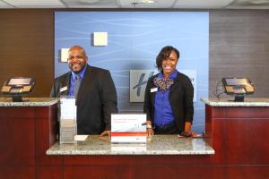 a man and a woman standing at a counter at Holiday Inn Express Hotel & Suites - Atlanta/Emory University Area by IHG in Decatur +69 photos