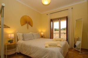 a bedroom with a large bed and a window at Casa da Barragem da Vigia in Redondo +19 photos