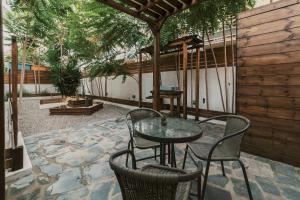 a patio with a table and chairs on a patio at Mailo&Luke apartments in Rhodes Town