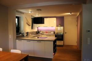 a kitchen with white cabinets and a counter top at Pantone Ultra in Dossenheim