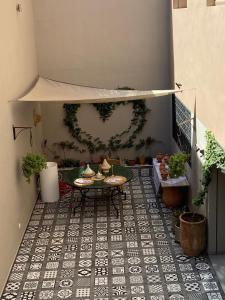 a patio with a table and a heart on the wall at VILLA De LUXE in Marrakesh