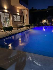 a swimming pool with blue lights in a house at VILLA De LUXE in Marrakesh