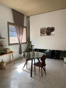 a living room with a glass table and a chair at VILLA De LUXE in Marrakesh