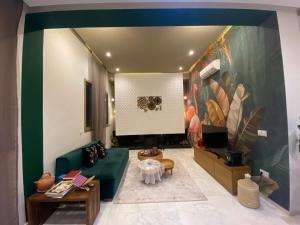 a living room with a green couch and a table at VILLA De LUXE in Marrakesh