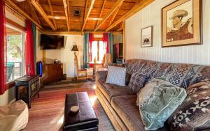 a living room with a couch and a table at Carter`s Charm Cabin in Ruidoso