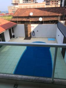 a view from the balcony of a house with a blue pool at Pousada Souza & Souza in Barra Velha