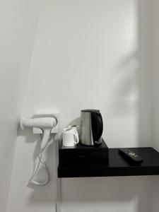 Un mostrador negro con un teléfono y una cafetera. en Romany House Hotel, en Londres 32 fotos más