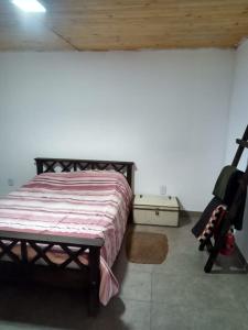 a bedroom with a bed and a chair in a room at Finca Doña Antonia in Pueblo Moreno