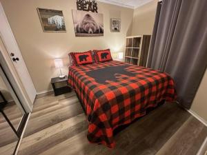 a bedroom with a bed with red pillows on it at Bear Canyon Condo #129 in Ruidoso