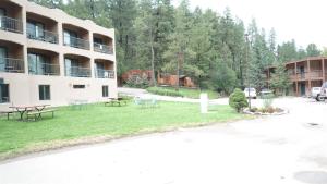 a building with tables and benches in a yard at Bear Canyon Condo #129 in Ruidoso