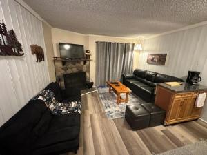 a living room with a couch and a fireplace at Bear Canyon Condo #129 in Ruidoso
