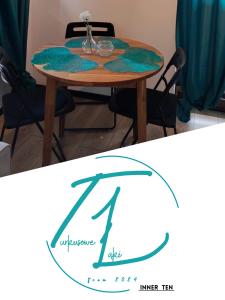 a dining room table with a green rug on it at Apartament Turkusowe Łąki 4c-1 in Mosty