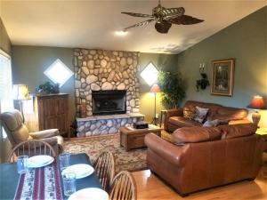 a living room with a couch and a fireplace at Big Bear Cabin in Ruidoso