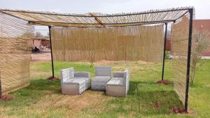 two chairs and a pergola in a yard at Sasa in Ech Chaïbat