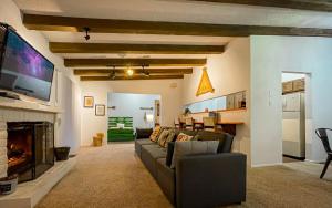 a living room with a couch and a fireplace at Casita Escondida in Alto