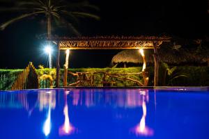 a swimming pool at night with a hacienda at villa wetdreams in Itarema