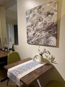 a table with a vase sitting on top of it at Cozy & Minimalist Staycation - Avida Towers with Pool Access in Davao City