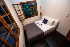 a small bedroom with a bed and a window at Bocas Sunset Beach House in Bocas del Toro