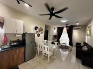 a kitchen and living room with a ceiling fan at Casa D'Faiz Alanis near KLIA pool olympic size in Sepang
