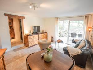 a living room with a couch and a table at La grande Pinède in Faucon