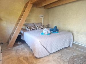 a bedroom with a white bed with a ladder at La grande Pinède in Faucon +53 photos