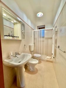 a bathroom with a sink and a toilet and a shower at Villa La Rosa in Chiaramonte Gulfi +49 photos