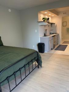 a bedroom with a bed and a kitchen in a room at Studio Stay in West Covina