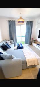 a bedroom with a large bed and a large window at شاليه فندقي mountain view north coast in Ras Elhekma +54 photos