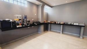 a room with a counter with aasteryasteryasteryasteryasteryasteryasteryasteryastery at Unity Hotel - Sorocaba in Sorocaba