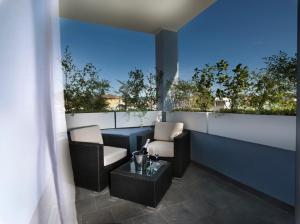 a balcony with two chairs and a table on a building at Blu9 Hotel in Novedrate