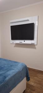 a flat screen tv hanging on a wall at Apartamento vista mar Santos in Santos