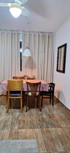 a dining room with a table and four chairs at Apartamento vista mar Santos in Santos