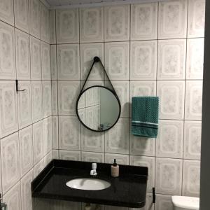 a bathroom with a mirror and a sink at Pousada Vista das Pedras in Pancas +9 photos