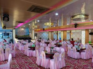 a banquet hall with pink chairs and tables in a room at Nhat Quy Hotel in Tây Ninh