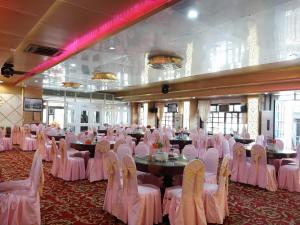 a banquet hall with white chairs and tables in a room at Nhat Quy Hotel in Tây Ninh
