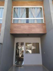 a view of a house with two windows at Sobrado novo - Oktoberfest in Blumenau