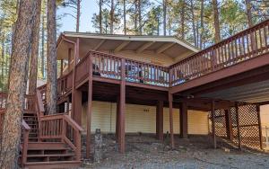 a house with a large deck in the woods at Mama Bears Cabin in Ruidoso