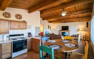 a kitchen and dining room with a table in a room at Mama Bears Cabin in Ruidoso