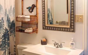 a bathroom with a sink and a mirror at Mama Bears Cabin in Ruidoso +21 photos