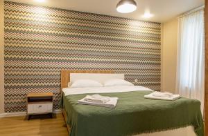 Letto o letti in una camera di Manoni Ratiani's Guesthouse
