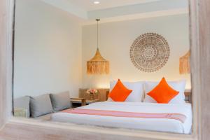 a bedroom with a large bed with orange pillows at LOVE beach club Koh Samui in Chaweng
