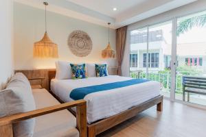 a bedroom with a bed and a large window at LOVE beach club Koh Samui in Chaweng