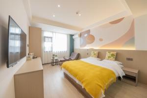 a bedroom with a bed with a yellow blanket at 乌镇闲情逸致精品民宿 in Wujiaqiao