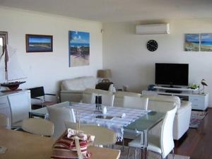 a living room with a table and a couch at St Helens Beachfront in Edithburgh